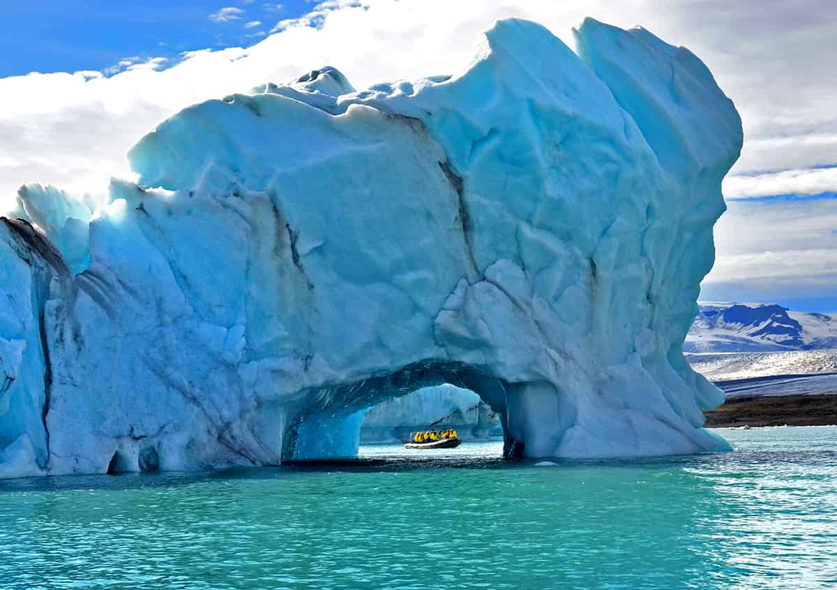 Glacial arch, boat and sea in Iceland
