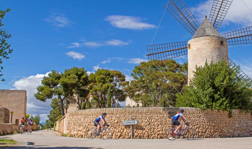 Biking past a windmill in Mallorca, Spain