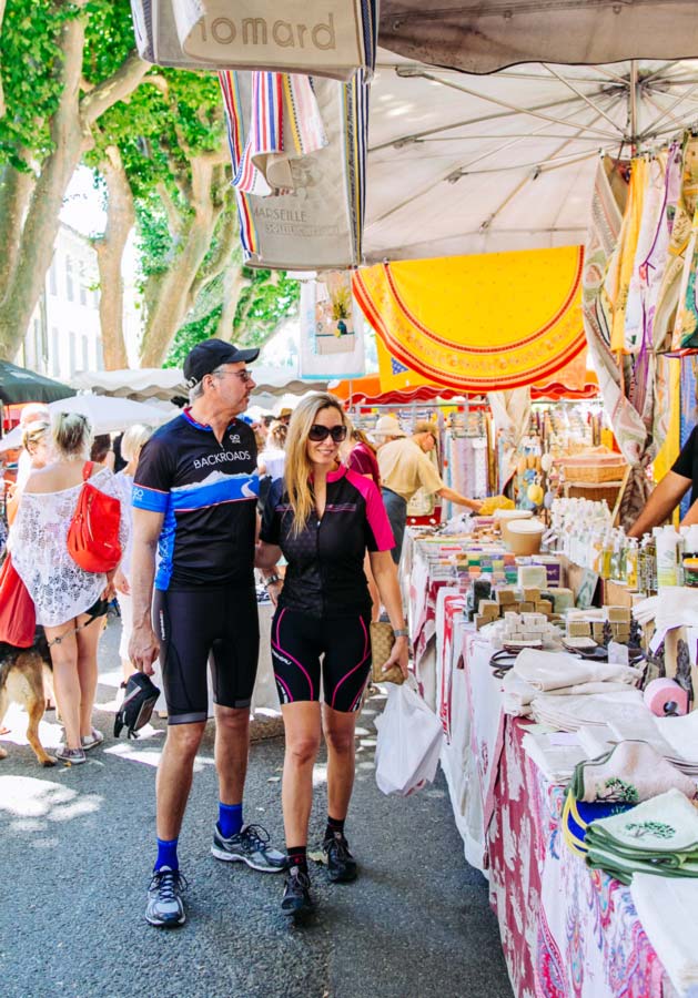 Backroads bikers shopping at an outdoor Market in France