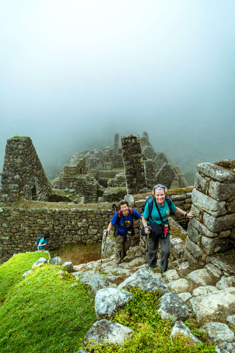 Climbing the steps of Machu Picchu, Peru