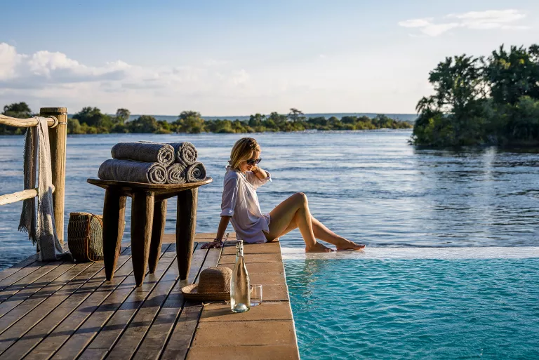 Woman with her feet in the water at Sanctuary Sussi &amp; Chuma