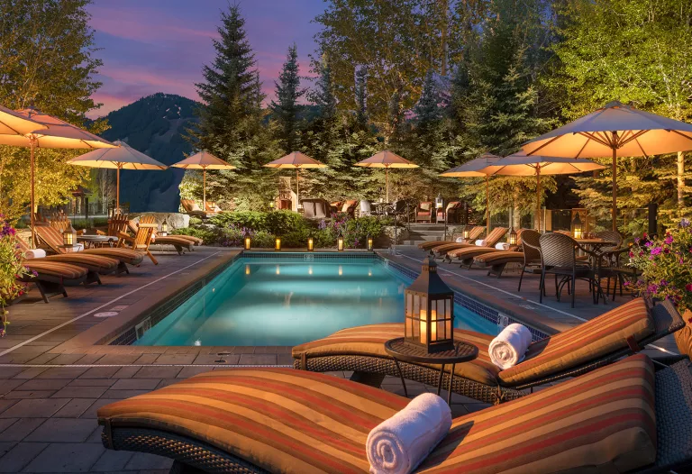 Exterior view of Rustic Inn Resort pool at night.