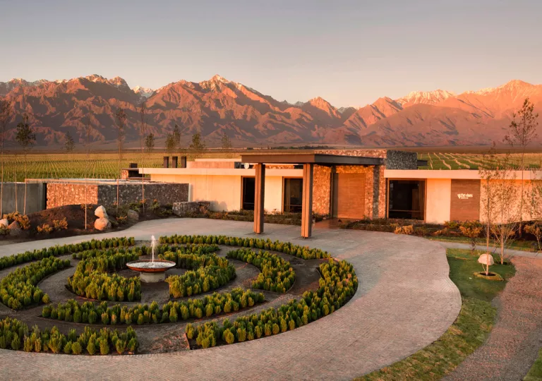 entrance to hotel with mountains in backdrop