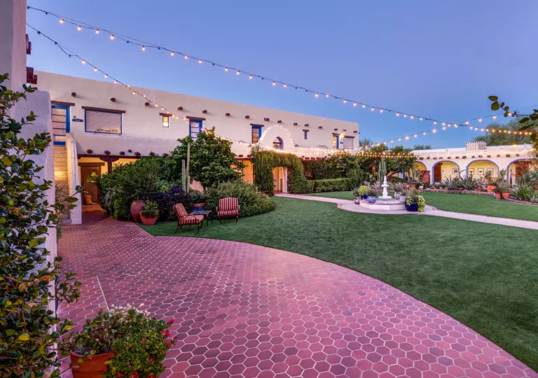 Outdoor courtyard with red brick, and a small fountain in the center