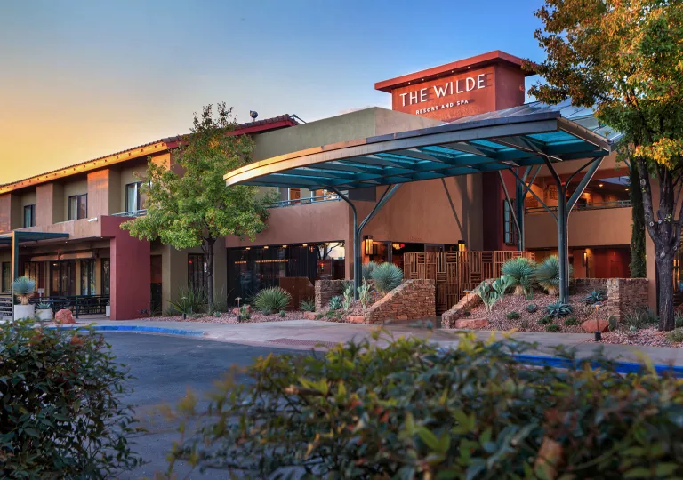 Exterior view of hotel building with stone accents and glass doors