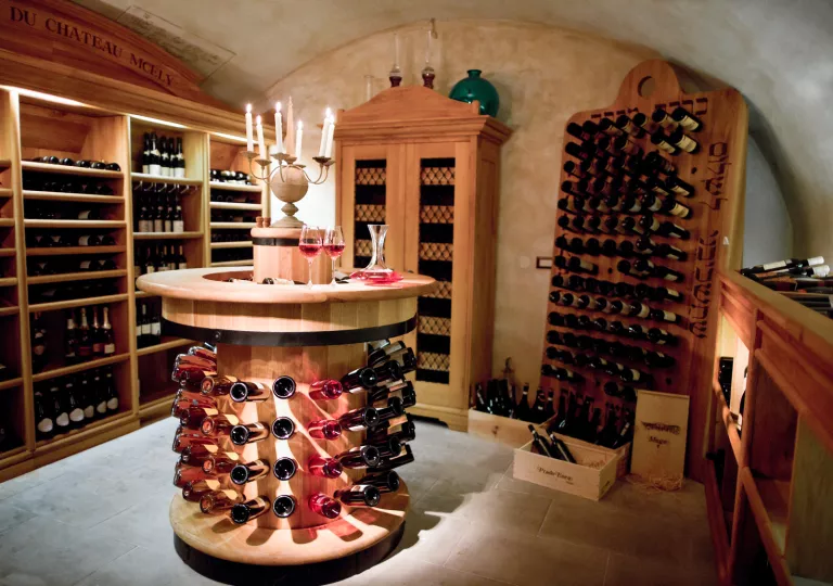 Wine cellar with wooden shelves full of wine bottles