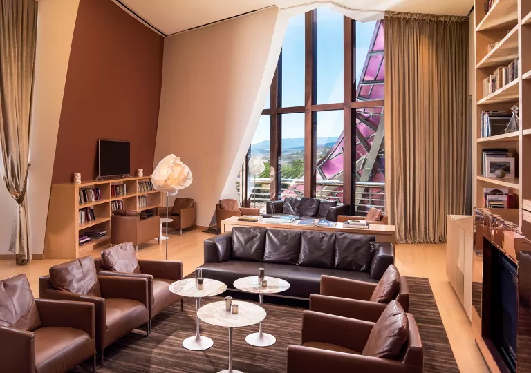 Indoor lounge and library with leather, cushioned sofas and chairs