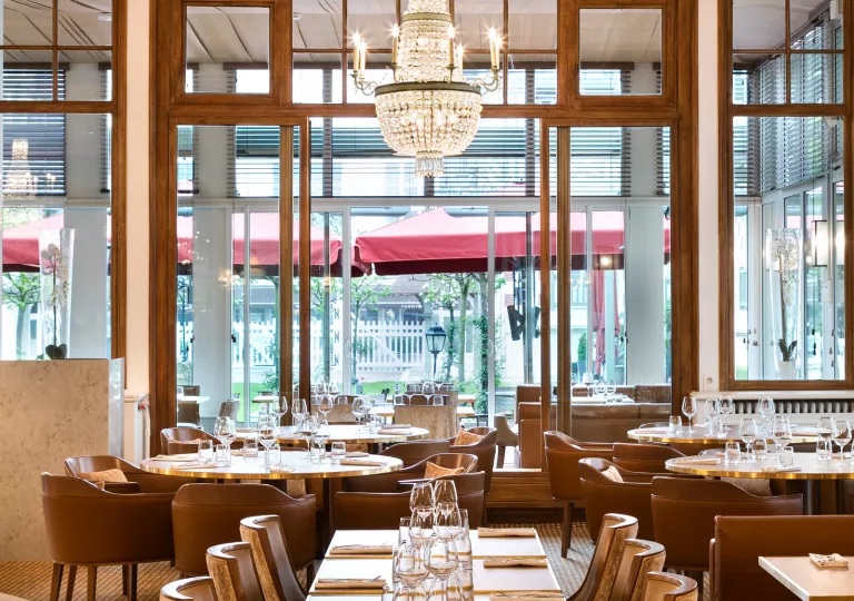 Indoor dining area with leather seats and wine glasses on each table