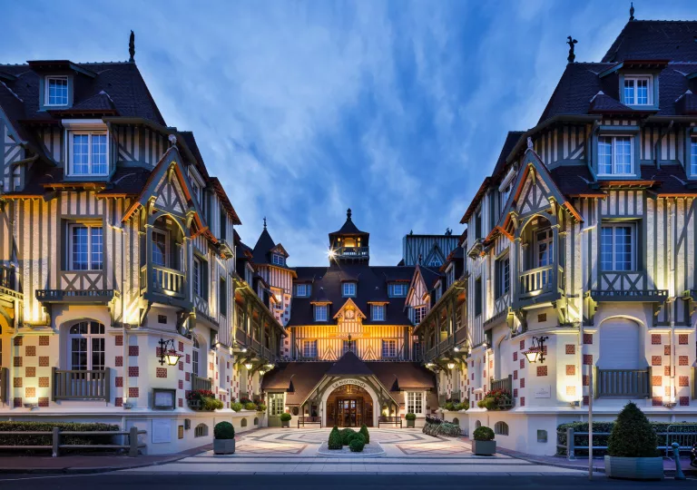 Exterior view of white buildings with blue accents and red checkers