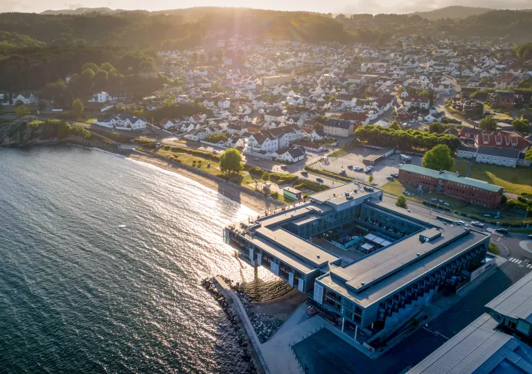 aerial shot of hotel on the water