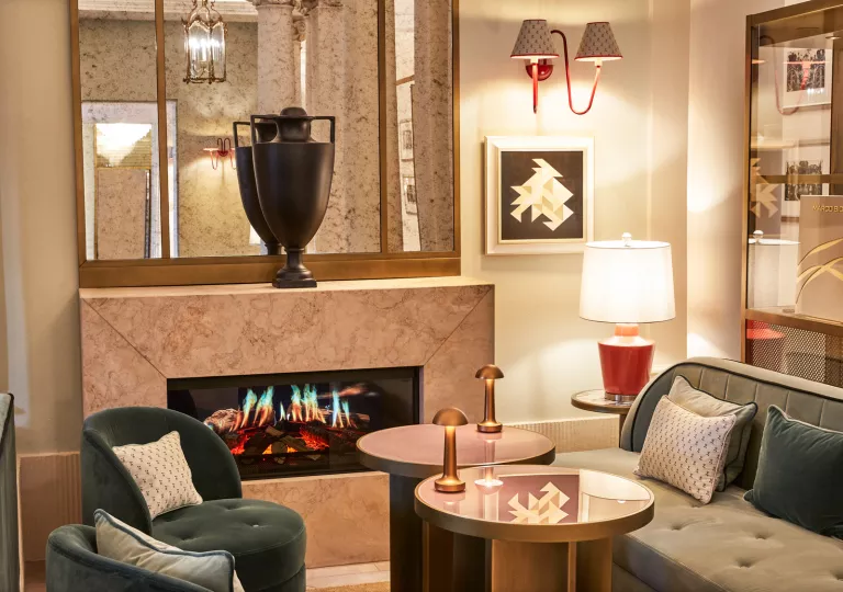 Indoor lounge with a fireplace and a vase on top