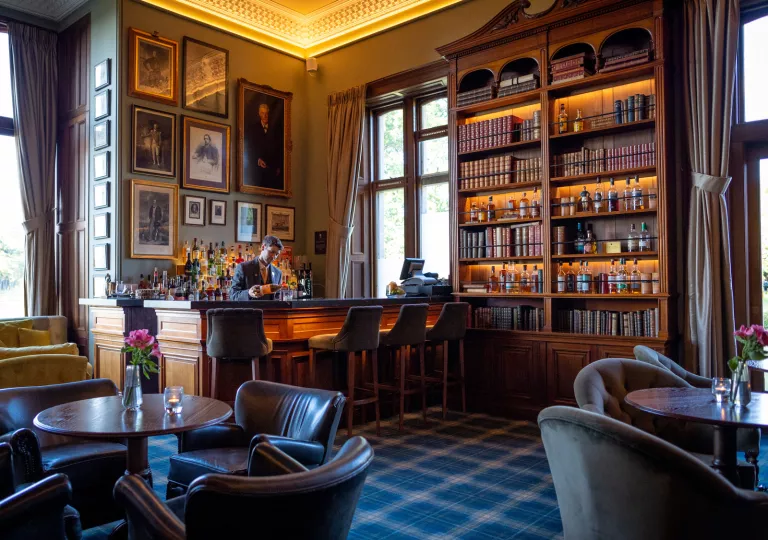 Hotel lobby with bar and bookshelves