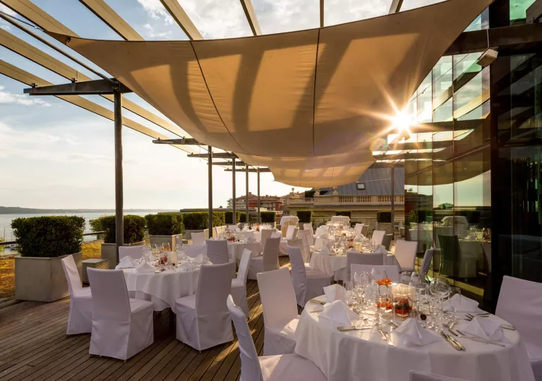 White dining tables on a large patio