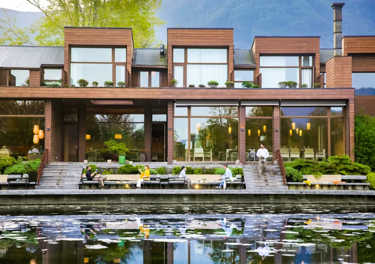 exterior of hotel and deck on the river