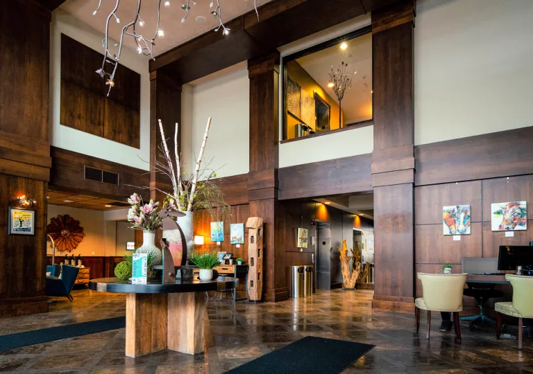 Indoor lobby with a wooden table and vase centerpiece
