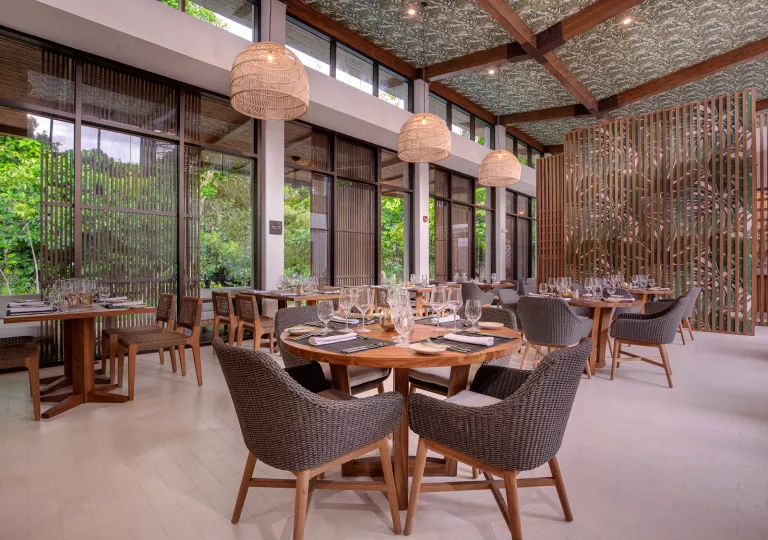 Indoor dining hall with glasses of wine on each table