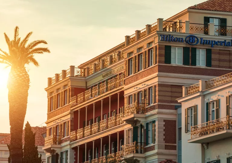 hotel at sunset with a palm tree