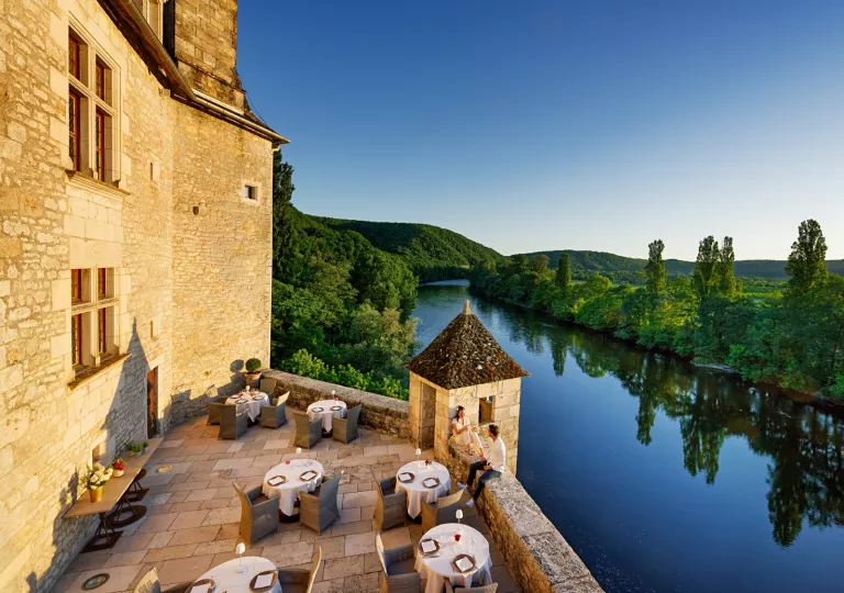 dining tables on outside patio by the river