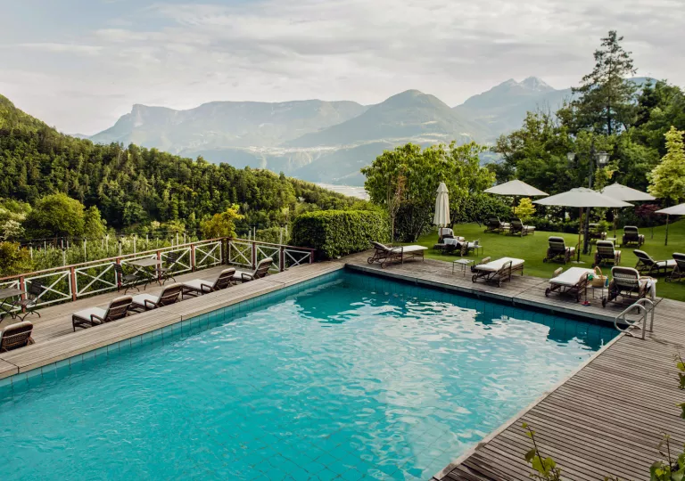 pool with lounge chairs and view of mountains