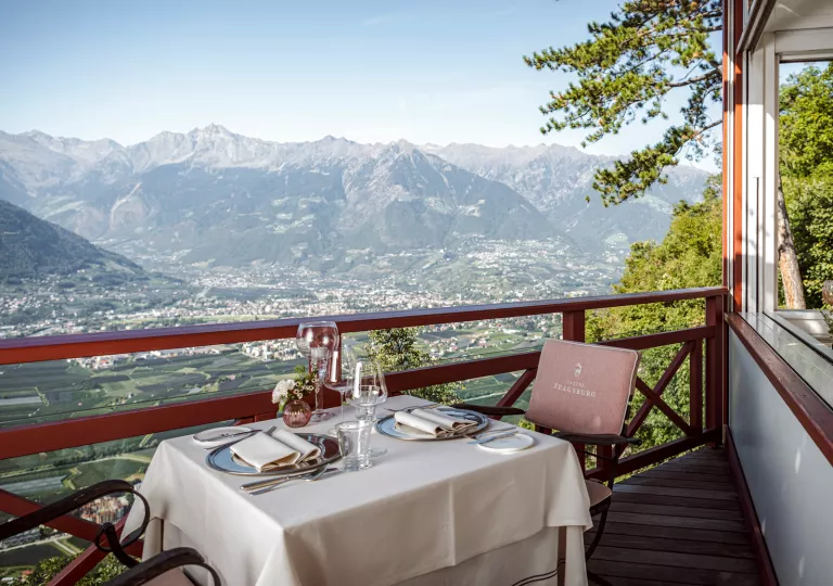 table on balcony with view of mountain range