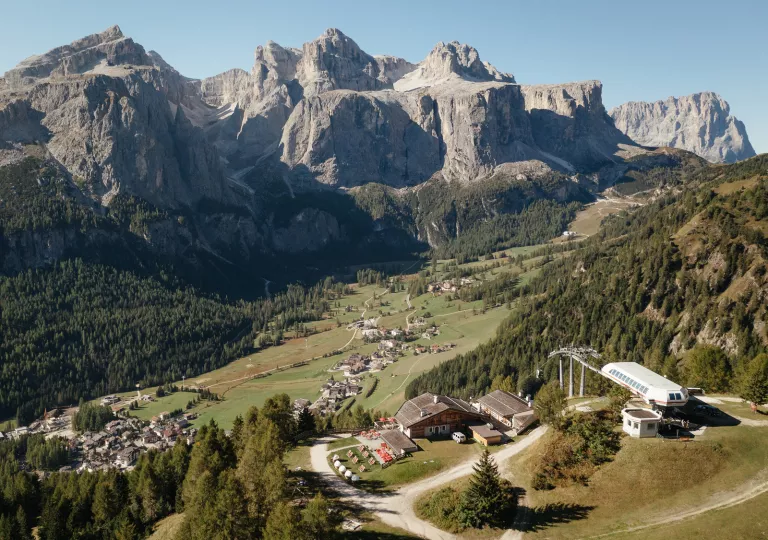 Large mountains in the background with small buildings on ground level