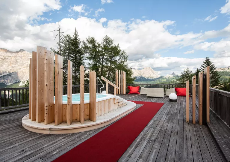 Rooftop deck with a hot tub, looking out to mountains