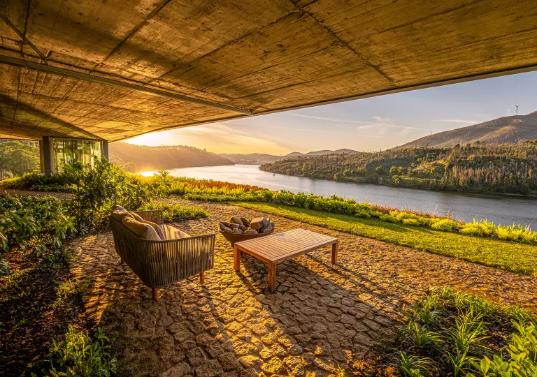 seating under a sunshield looking out over the water