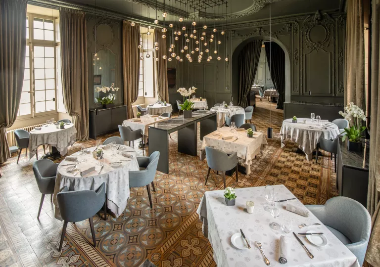 ballroom with dining tables and a chandelier