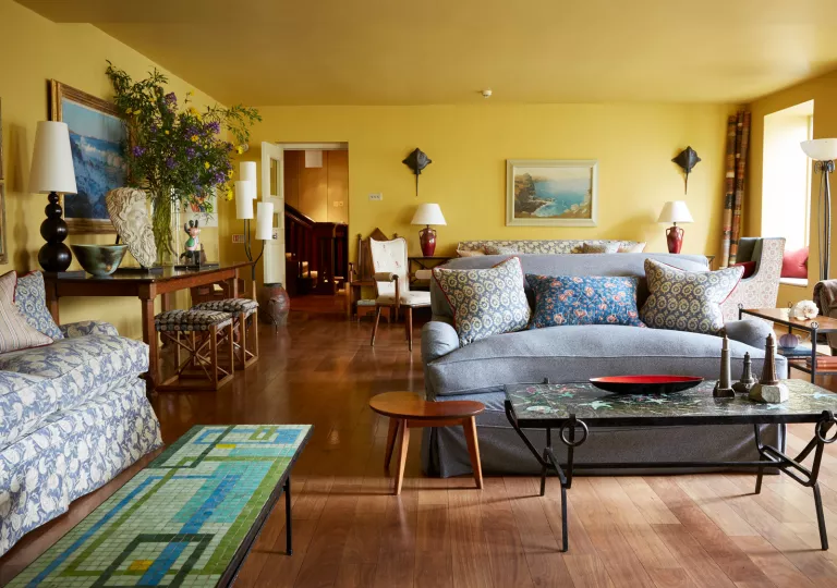 Living room with multiple couches and a marble table