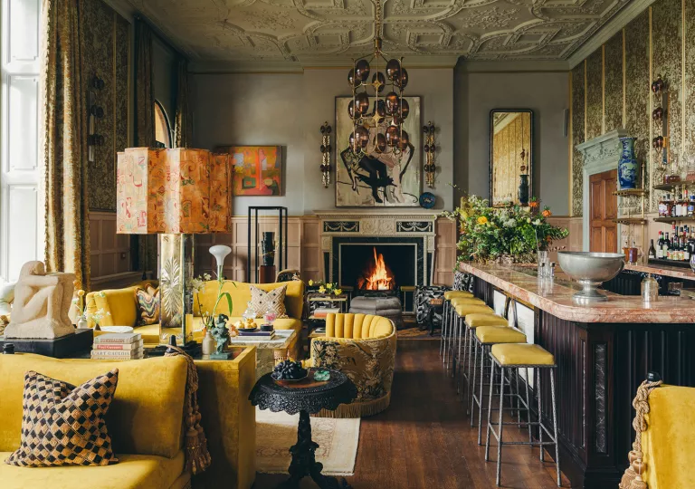 Indoor lounge with a fireplace and bar on the right