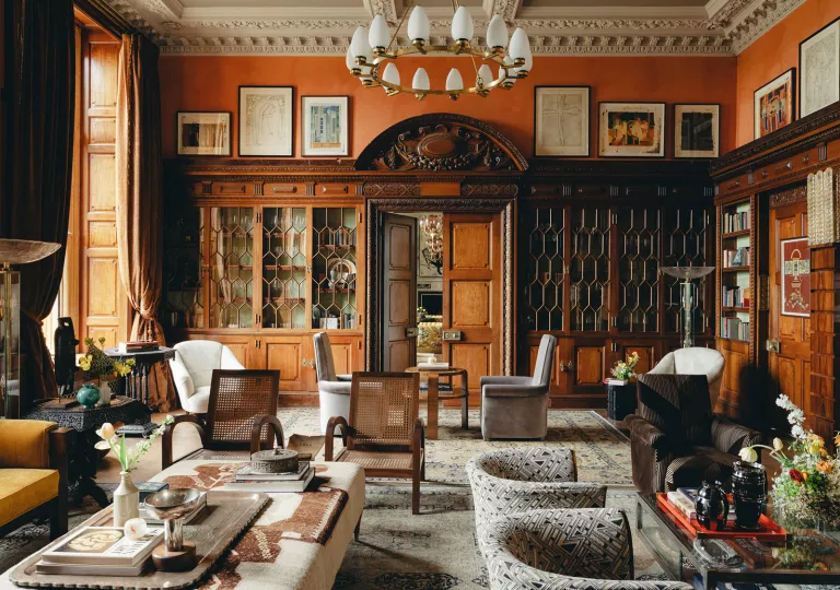 Indoor lounge with cushioned white chairs and tables