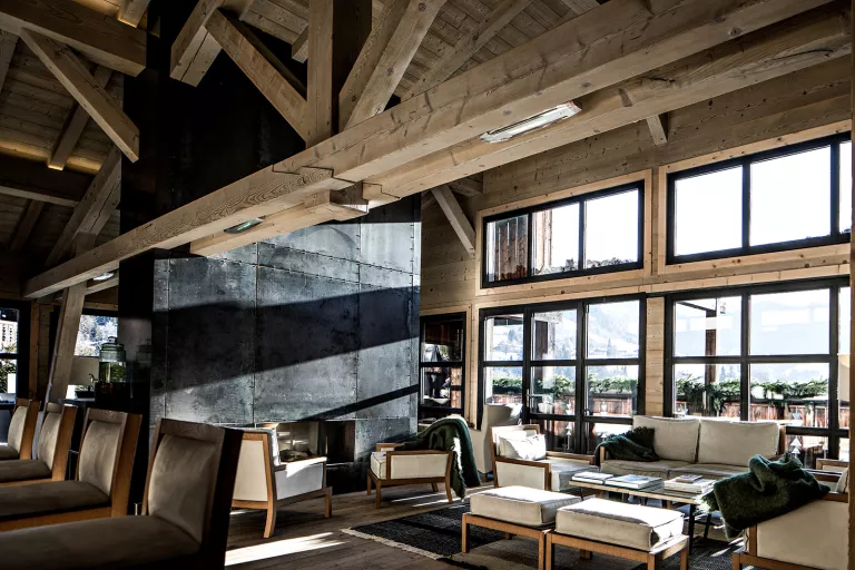 Lounge with wooden interior looking out to the forest