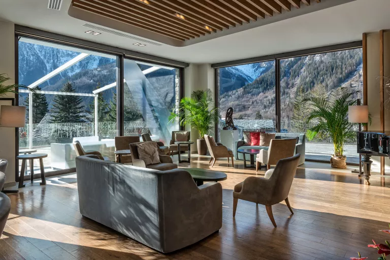 Indoor lounge with large windows looking out to mountains