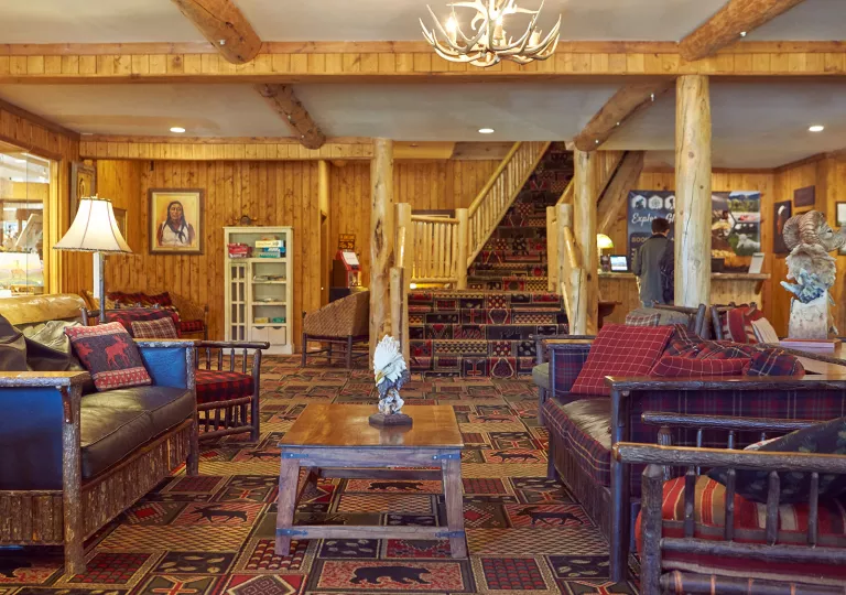 Lodge lobby with leather couches and a concierge