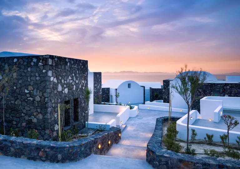 Gray and white stone villas with pathways leading to each doorway
