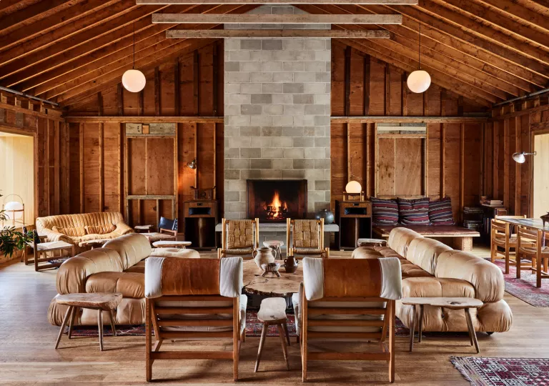 Indoor cottage lobby filled with leather couches and wooden furniture