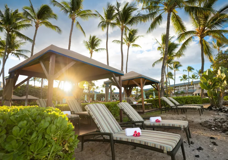 Rolled towels on reclining chairs by the beach