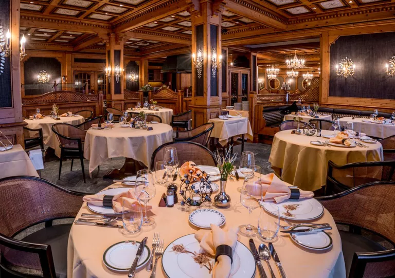 Indoor dining area with wine glasses and tables cloths