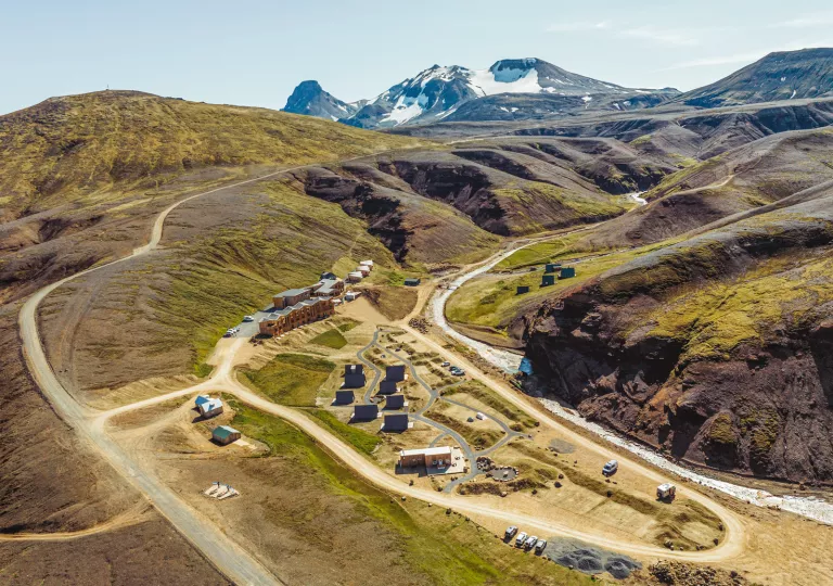 Hotel property in the middle of an empty valley of dirt and grass