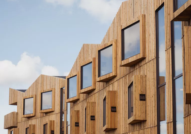 Large windows on the third story of a hotel building