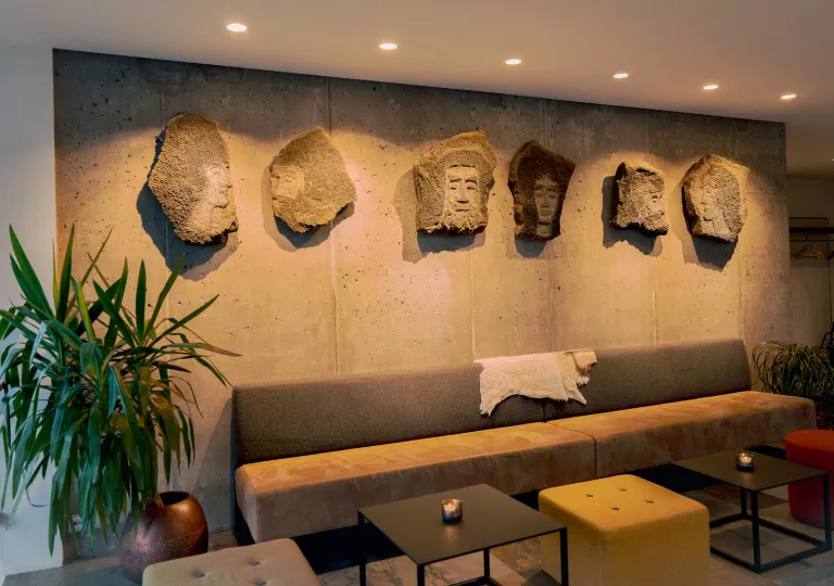couch with stone statues hung above it