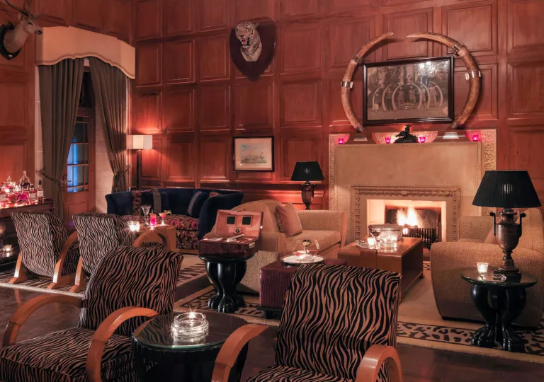 Indoor lounge with a fireplace and zebra-striped cushioned chairs