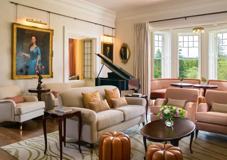 Lobby with cushioned couches and a piano in the back