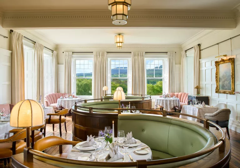 Half-circle shaped seating booths with a dining table in the center