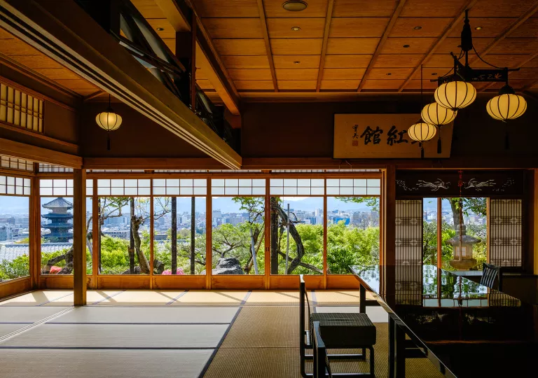Japanese interior with black shiny tables and tatami mats on the floor