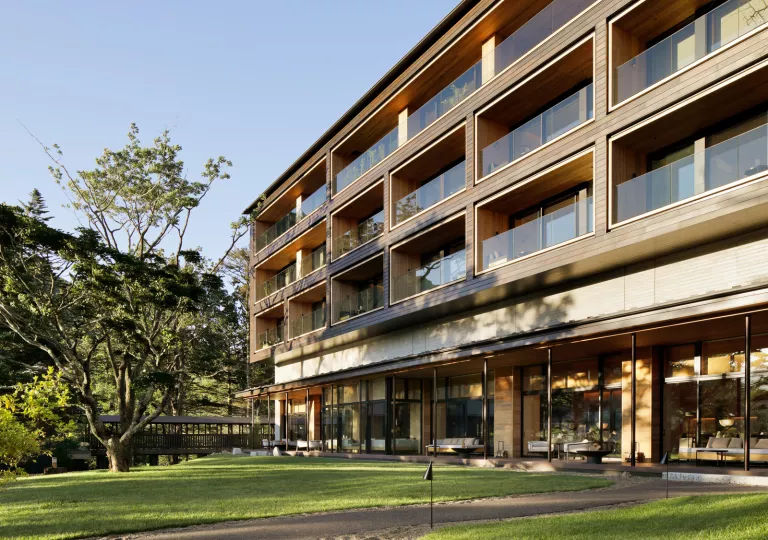 Exterior of a multi-story building with glass balconies on each level