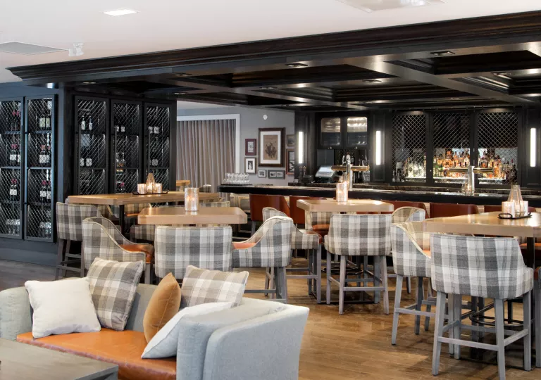 Indoor lounge with to a cage full of wine