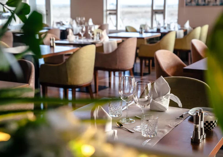 Dining room with two empty wine glasses on the table