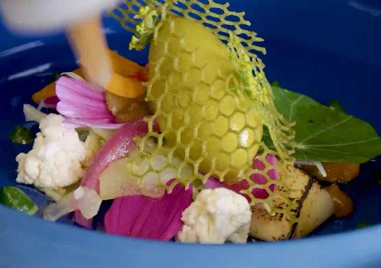 Blue bowl full of roasted vegetables and plated