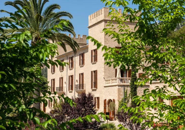 large stone building surrounded by lush greenery